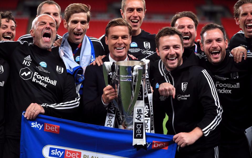 Scott Parker, pictured here holding the trophy with Fulham's backroom staff  - PA