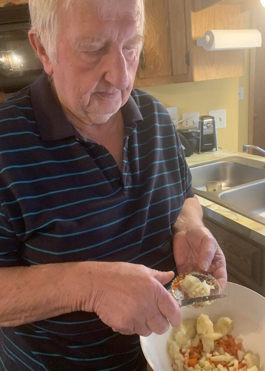 George Burzynski prepares Polish vegetable salad at home, one of the 12 traditional dishes served for Wigilia dinner, on Christmas Eve. He used to prepare the salad for customers at his Polonez Restaurant, which would offer the family-style dinner for takeout.