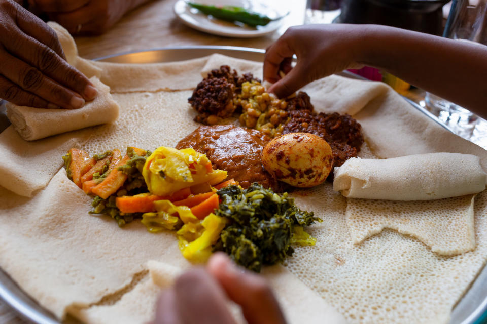 people eating Ethiopian food with their hands