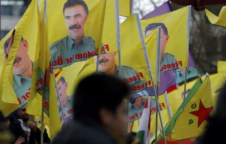 People carry a flags with the picture of imprisoned Kurdish rebel leader Abdullah Ocalan during a demonstration organised by Kurds, in Frankfurt, Germany, March 18, 2017. REUTERS/Ralph Orlowski