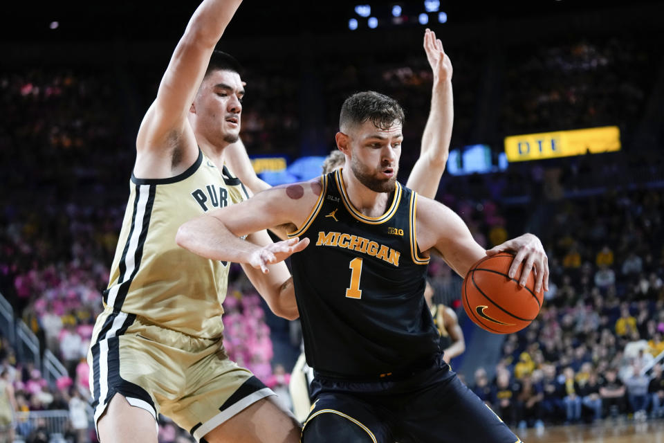 Michigan center Hunter Dickinson (1) backs down Purdue center Zach Edey (15) in the second half of an NCAA college basketball game in Ann Arbor, Mich., Thursday, Jan. 26, 2023. (AP Photo/Paul Sancya)