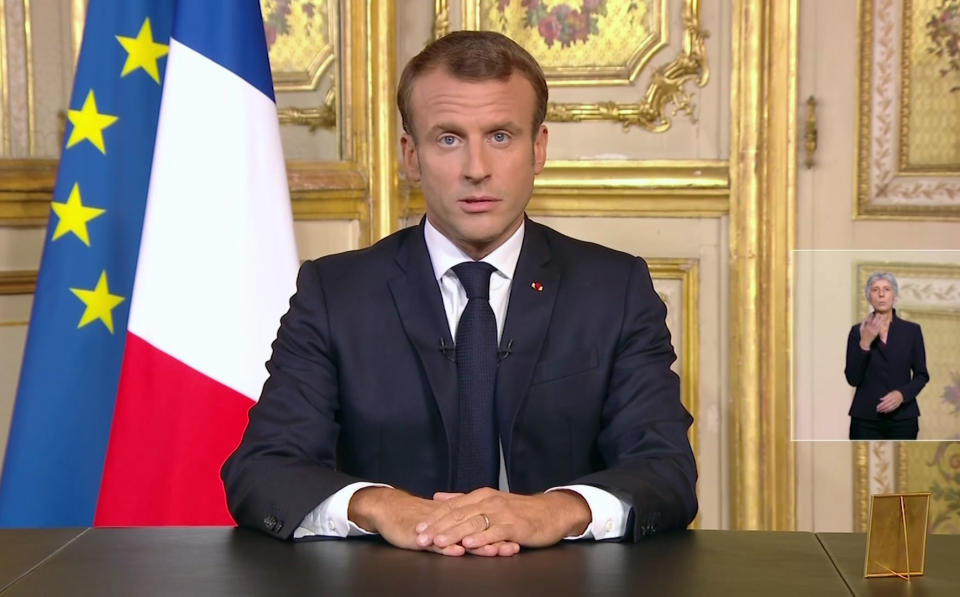 In this image made from video provided by TF1, France's President Emmanuel Macron delivers a speech in the Elysee Palace in Paris, Thursday, Sept. 25, 2019. Macron says former President Jacques Chirac is entering into history and will be missed by every French people. In a nationally televised speech Thursday, Macron told his “sadness” and “emotion” to the death of Chirac. “We are losing a statesman we loved as much as he loved us,” he said in a rare homage. (TF1 via AP)