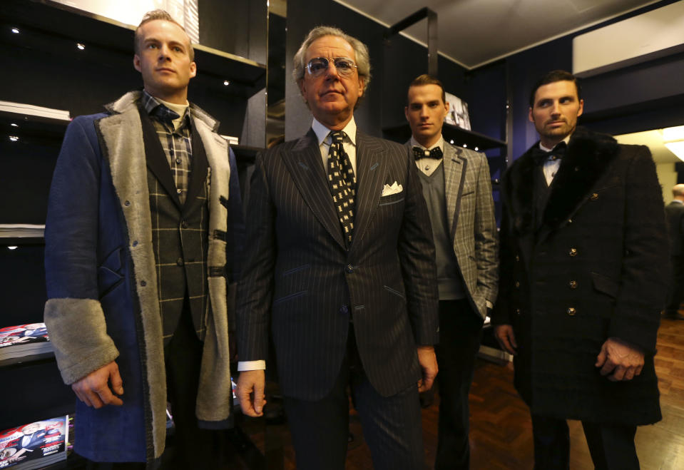 Italian fashion designer Angelo Galasso, second from left, poses with models during a presentation of the Angelo Galasso men's Fall-Winter 2013-14 collection, part of the Milan Fashion Week, unveiled in Milan, Italy, Sunday, Jan. 13, 2013. (AP Photo/Luca Bruno)