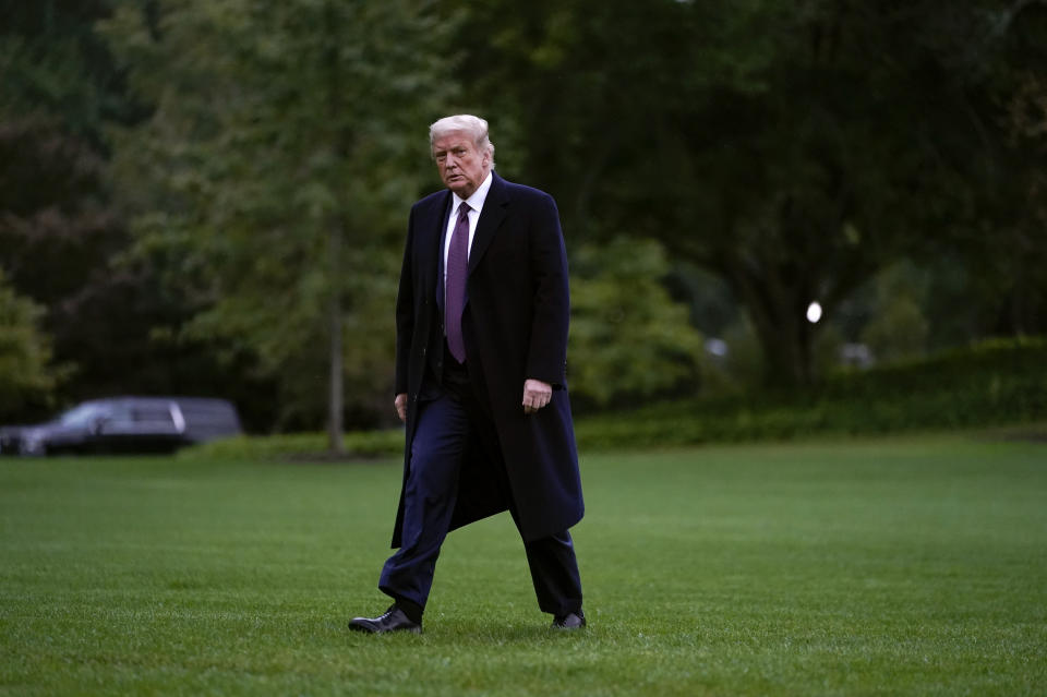 FILE - In this Thursday, Oct. 1, 2020 file photo, President Donald Trump walks from Marine One to the White House in Washington as he returns from Bedminster, N.J. On Friday, Oct. 2, 2020, The Associated Press reported on stories circulating online incorrectly asserting President Trump’s campaign sent an email asking supporters to donate as he recovers from COVID-19. Posts with the fundraising appeal circulated on social media after Trump tweeted early Friday that he and wife, Melania, had tested positive for COVID-19. The letter had a Trump-Pence logo similar to that used by the campaign. But the message was fabricated, Trump campaign communications director Tim Murtaugh confirmed to the AP. (AP Photo/Carolyn Kaster)