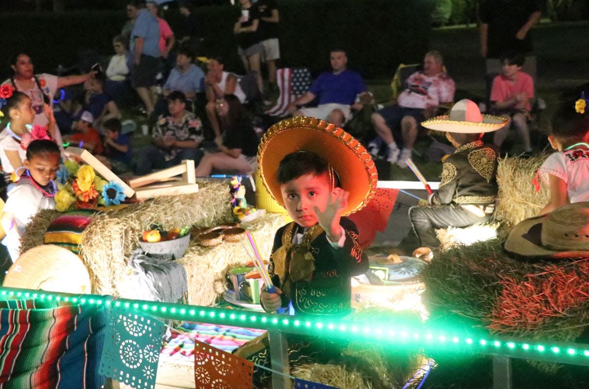 A young child waves to the crowd during the 2022 Sturgis Fest electric parade. The 2023 festival returns June 20-24.
