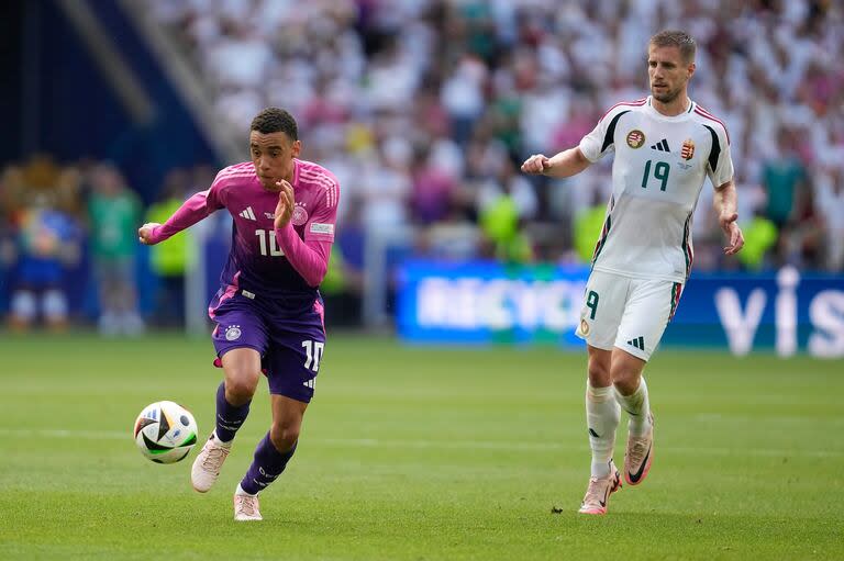 Musiala, con la vista puesta en la pelota en un avance de Alemania; atrás lo observa Varga 