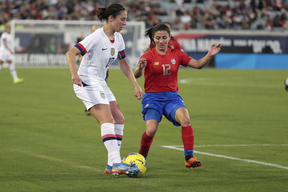 U.S. forward Carli Lloyd, left, works for possession against Costa Rica defender Lixy Rodriguez (12) during the first half of an international friendly soccer match Sunday, Nov. 10, 2019, in Jacksonville, Fla. (AP Photo/John Raoux)