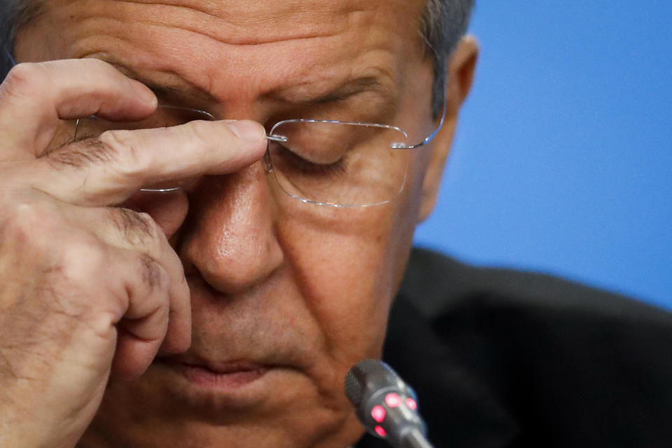 Russian Foreign Minister Sergey Lavrov adjusts his glasses while speaking about his department's 2018 accomplishments during his annual roundup news conference in Moscow, Russia, Wednesday, Jan. 16, 2019. Russia's foreign minister has ridiculed allegations that U.S. President Donald Trump could have worked for Moscow's interests. (AP Photo/Pavel Golovkin)