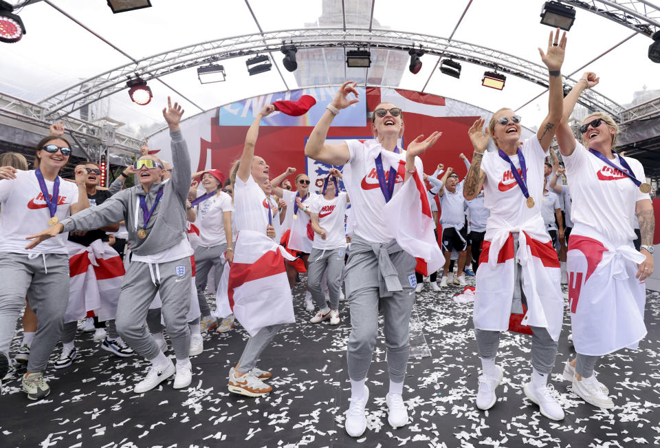 England players celebrate on stage at an event at Trafalgar Square in London, Monday, Aug. 1, 2022. England beat Germany 2-1 and won the final of the Women's Euro 2022 on Sunday. (James Manning/PA via AP)