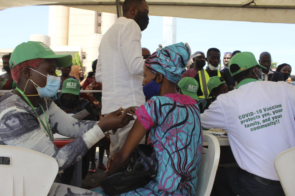 A Nigeria civil servant is administered the AstraZeneca coronavirus vaccine, in Abuja, Nigeria , Wednesday, Dec. 1, 2021. Nigeria has detected its first case of the omicron coronavirus variant in a sample it collected in October, weeks before South Africa alerted the world about the variant last week, the country's national public health institute said Wednesday. (AP Photo/Gbemiga Olamikan)