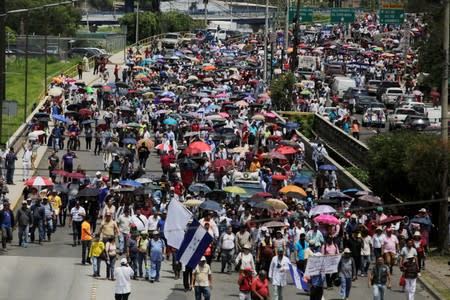 Demonstrators march against President Juan Orlando Hernandez government's plans to privatize healthcare and education, in Tegucigalpa