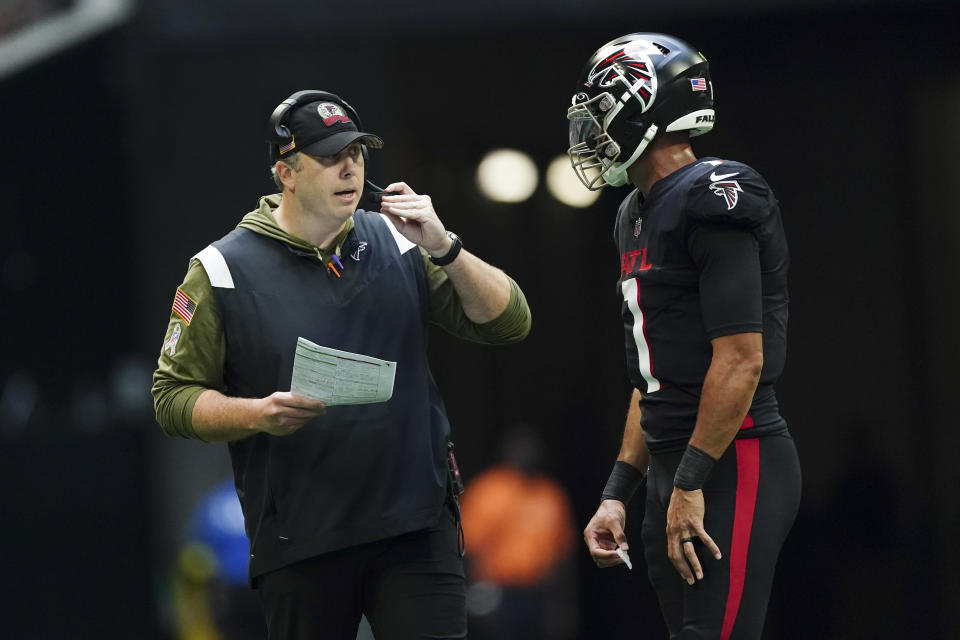 Atlanta Falcons head coach Arthur Smith talks with quarterback Marcus Mariota (1) during the second half of an NFL football game against the Los Angeles Chargers, Sunday, Nov. 6, 2022, in Atlanta. (AP Photo/John Bazemore)