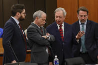 Prosecuting attorney Creighton Waters, center left, and defense attorney Jim Harpootlian confer before a hearing on a motion for Alex Murdaugh's retrial, Tuesday, Jan. 16, 2024, at the Richland County Judicial Center in Columbia, S.C. Murdaugh was convicted of killing his wife, Maggie, and younger son, Paul, in June 2021. (Tracy Glantz/The State via AP, Pool)