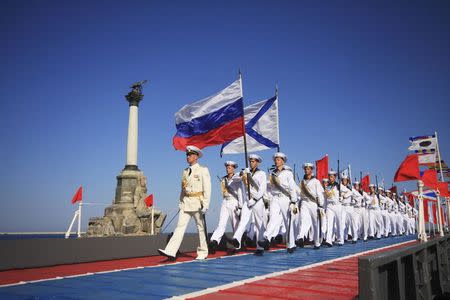 Russian sailors march during celebrations to mark Navy Day in the Crimean port of Sevastopol July 27, 2014. REUTERS/Stringer