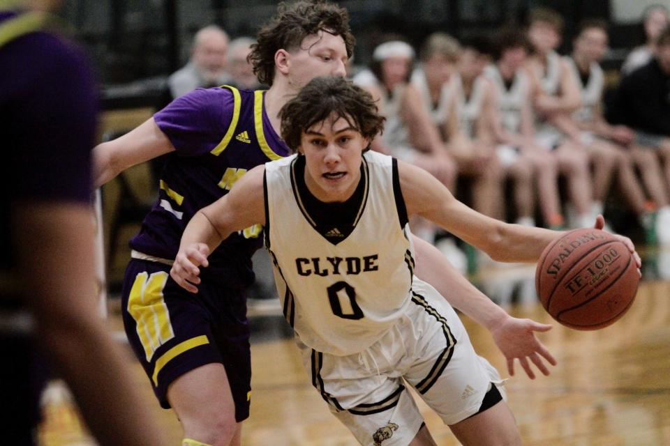 Clyde's Conner Hawk drives against Merkel's Reid Hoyle.