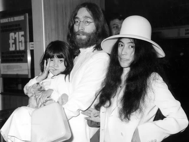 <p>Central Press/Getty </p> John Lennon and Yoko Ono with Yoko's daughter Kyoko at London's Heathrow airport.