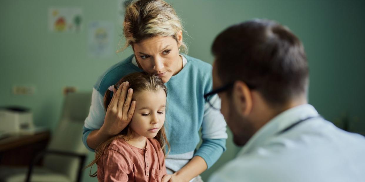 worried mother and her daughter having a medical appointment with doctor