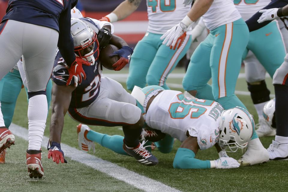 New England Patriots running back Sony Michel scores a touchdown against the Miami Dolphins in the first half of an NFL football game, Sunday, Dec. 29, 2019, in Foxborough, Mass. (AP Photo/Elise Amendola)