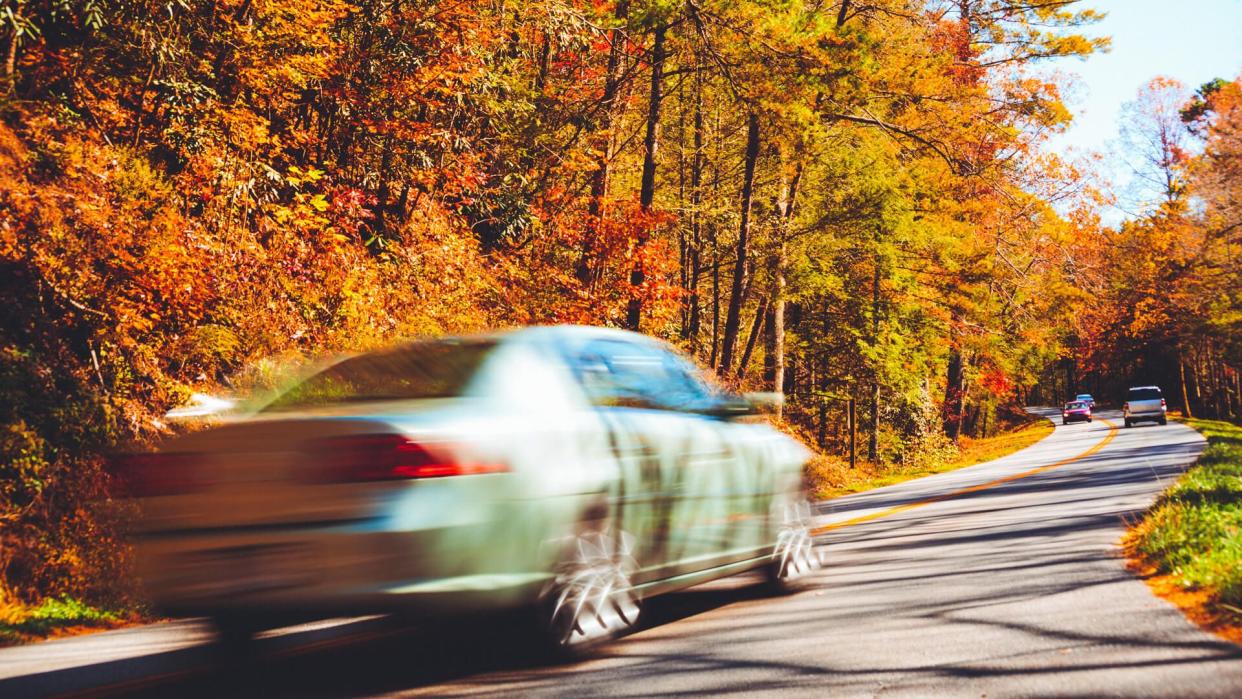 Car driving in a country road in the Great Smoky Mountains National Park in Tennessee, USA.