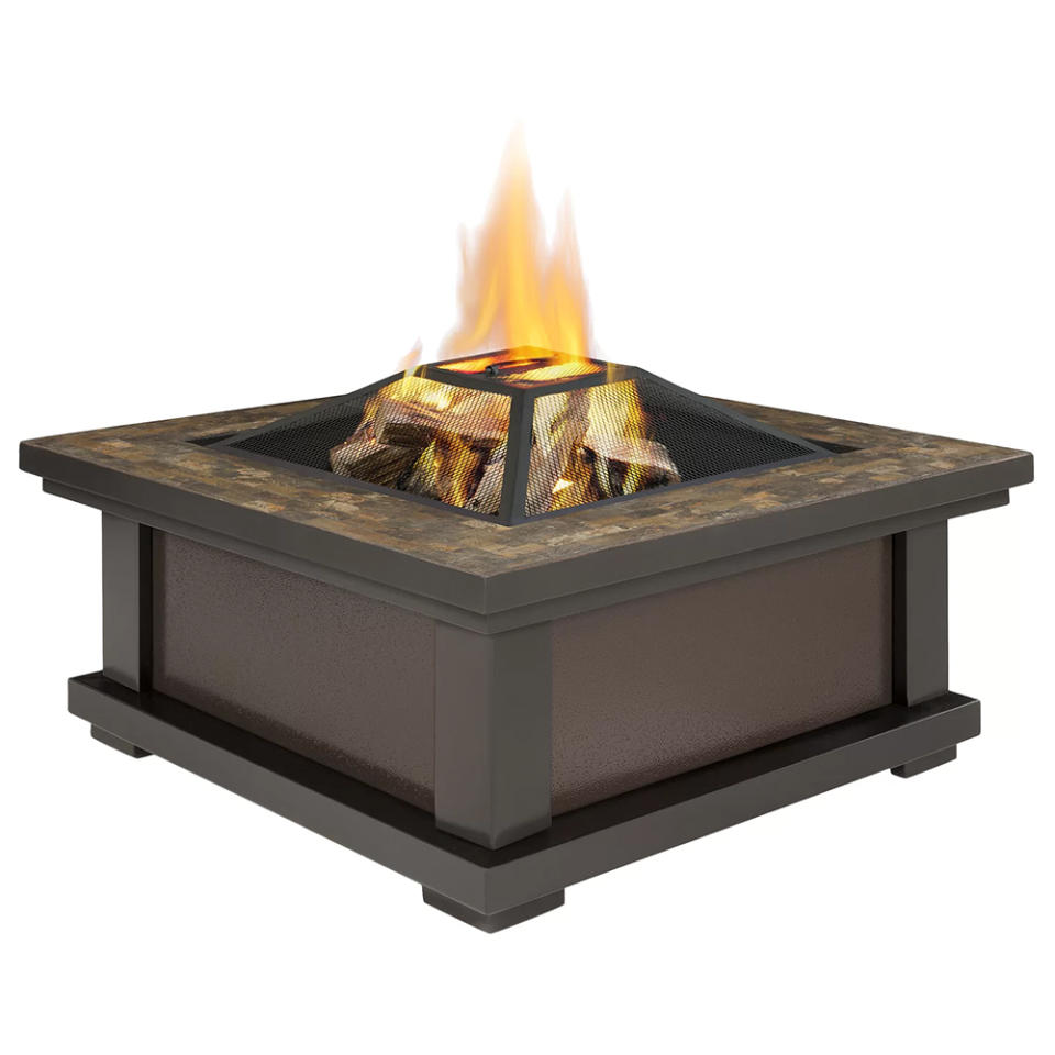 This sleek fire pit also comes with a protective storage cover and log poker tool (Photo: Wayfair)