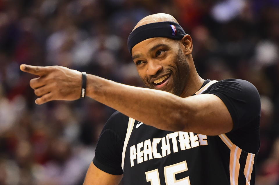 Atlanta Hawks guard Vince Carter smiles and points during a break in play during the first half of the team's NBA basketball game against the Toronto Raptors on Tuesday, Jan. 28, 2020, in Toronto. (Frank Gunn/The Canadian Press via AP)