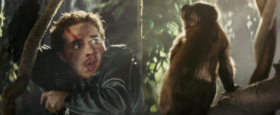 A scene from the movie "Nope" showing Brandon Perea's character frightened, with a red mark on his forehead, and a monkey staring at him