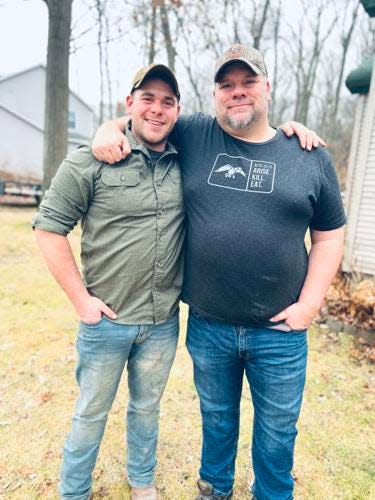 Braden Peltier, left, and his father, Jay, pose for a picture on Jan. 2 in Grand Haven.