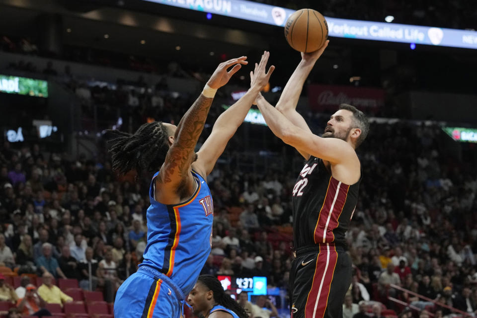 Miami Heat forward Kevin Love (42) aims a shot as Oklahoma City Thunder forward Jaylin Williams (6) defends during the first half of an NBA basketball game, Wednesday, Jan. 10, 2024, in Miami. (AP Photo/Marta Lavandier)