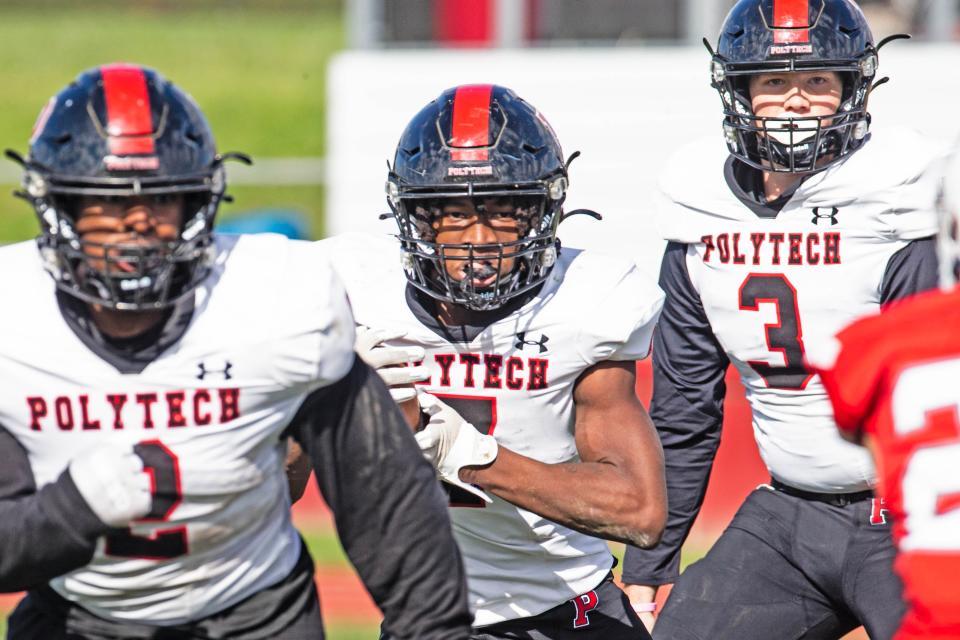 Polytech junior Noah Walker (7) runs the ball, with juniors Dionysus Alston (2) and Isaac Balcerak (3) covering, against Conrad during the football game at the Conrad Schools of Science in Wilmington, Saturday, Oct. 21, 2023. Polytech won 30-24.