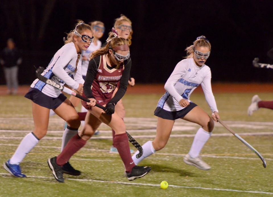 Sandwich's Megan Dwyer, right, tries to block a first quarter pass by Newburyport's Ciara Geraghty.