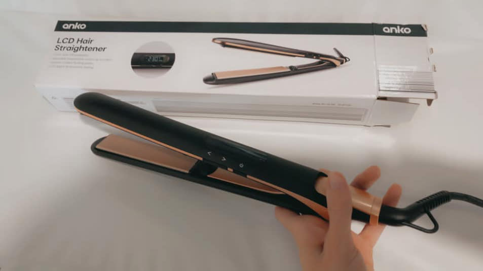 Woman holds Anko LCD Hair Straightener after praising it as 'amazing' budget dupe of high-end products