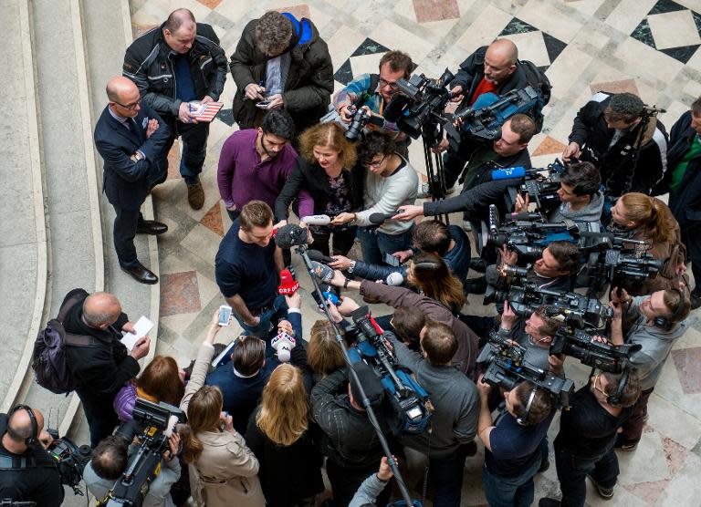 Austrian activist Max Schrems talks to journalists in the courthouse after officially filing a suit against Facebook in Vienna on April 9, 2015