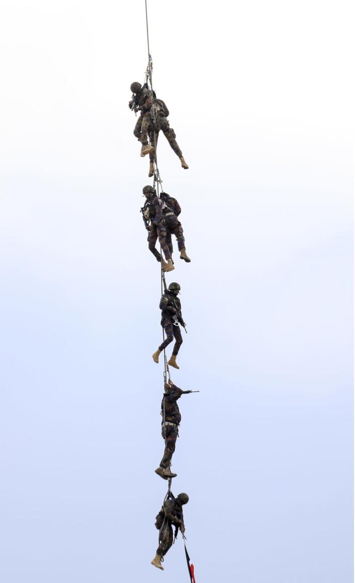 The Kenya Airforce paratroopers perform during the Kenya Defence Forces (KDF) Museum Air Show Festival over the Uhuru Gardens Memorial Park in Nairobi, Kenya, 28 May 2022. The Air Show which was led by Kenya Air Force, boasted displays of both military and civilian aerobatic capabilities aimed at engaging and entertaining the public.