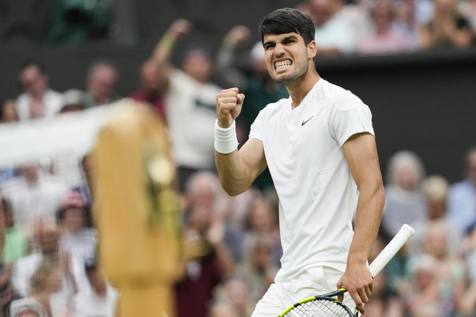 Spain's Carlos Alcaraz reacts after winning a point against Francis Tiafoe of the United States during their third round match at the Wimbledon tennis championships in London, Friday, July 5, 2024. (AP Photo/Alberto Pezzali)