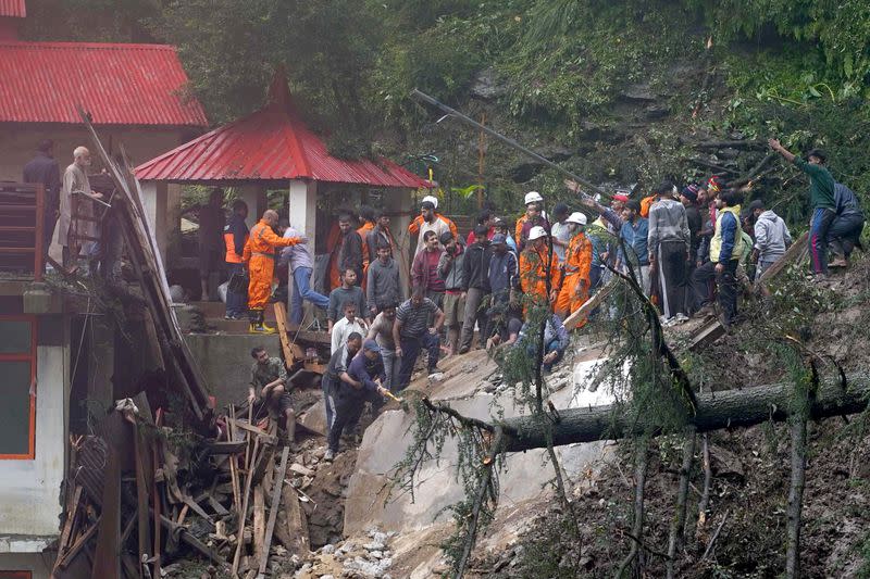 FILE PHOTO: Rescue workers remove the debris as they look for survivors after a landslide following torrential rain in Shimla