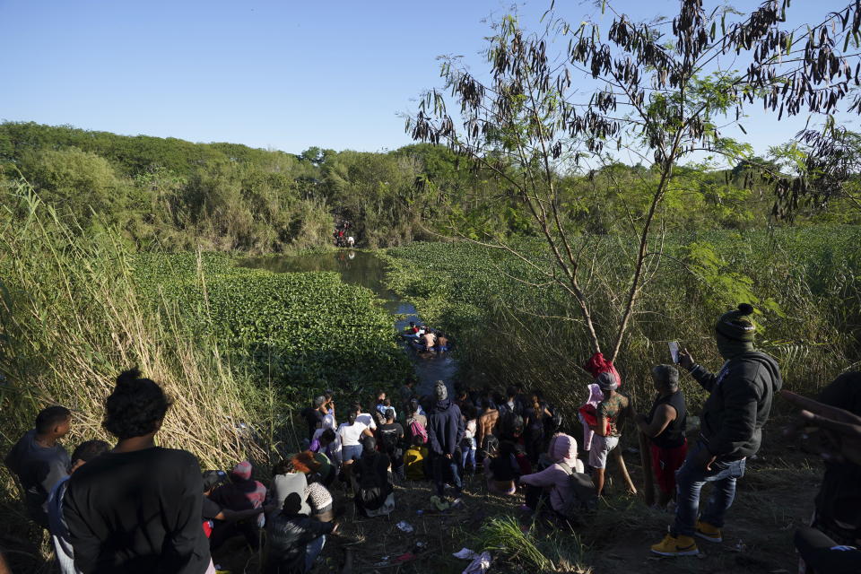 Venezuelan migrants cross a river towards U.S territory from a river bank in Matamoros, Mexico, Thursday, Dec. 22, 2022. (AP Photo/Fernando Llano)