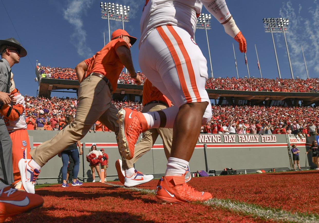 Oct 28, 2023; Raleigh, North Carolina, USA; Clemson Tigers head coach Dabo Swinney runs with the team on the field before a game against the North Carolina State Wolfpack at Carter-Finley Stadium. Mandatory Credit: Ken Ruinard-USA TODAY Sports