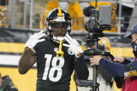 Pittsburgh Steelers wide receiver Diontae Johnson (18) mugs for the TV camera in the end zone after making a catch and then scoring a touchdown against the Baltimore Ravens during the second half of an NFL football game, Sunday, Dec. 5, 2021, in Pittsburgh. (AP Photo/Gene J. Puskar)