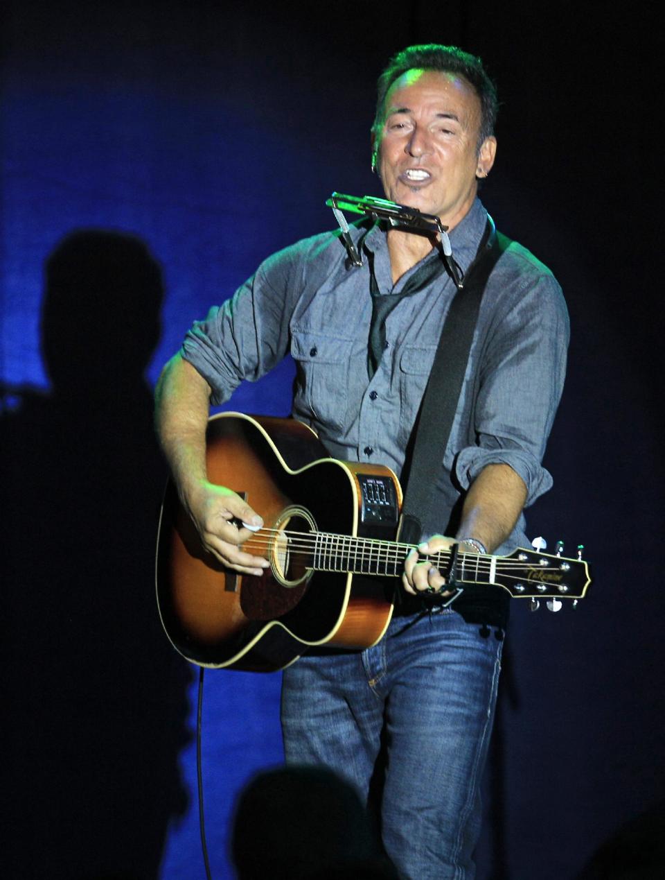 Singer/songwriter Bruce Springsteen performs at a campaign event for President Barack Obama, Thursday, Oct. 18, 2012, in Parma, Ohio. (AP Photo/Tony Dejak)