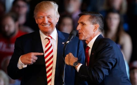 Michael Flynn with Donald Trump during the election campaign. He is now co-operating with investigators - Credit: Getty Images