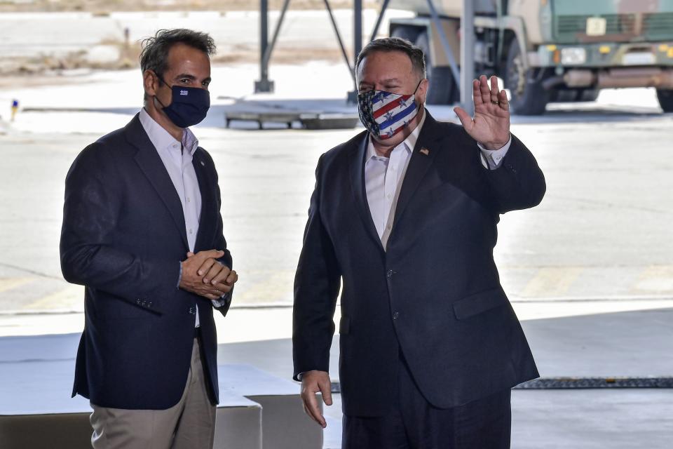 US Secretary of State Mike Pompeo, right, and Greek Prime Minister Kyriakos Mitsotakis pose during their visit at the Naval Support Activity base at Souda, on the Greek island of Crete, Tuesday, Sept. 29, 2020. Pompeo visited a U.S. naval base at Souda Bay on the southern Greek island of Crete Tuesday, ahead of a meeting with Greece's prime minister on the second day of his trip to the country. (Aris Messinis/Pool viaAP)