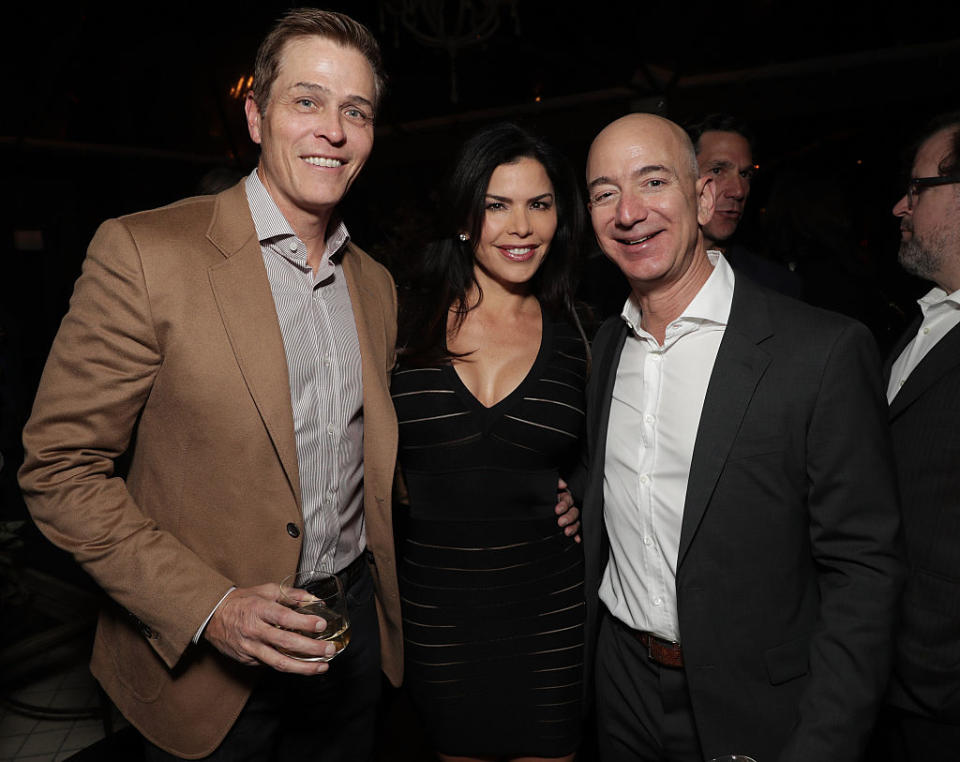 Patrick Whitesell, Lauren Sanchez and Jeff Bezos at a party on December 3, 2016 in Los Angeles, California. (Photo: Getty)