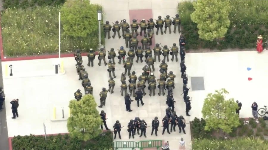 Law enforcement officers are seen approaching a protest encampment at UC Irvine on May 15, 2024. (KTLA)