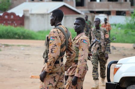 South Sudanese policemen and soldiers stand guard along a street following renewed fighting in South Sudan's capital Juba, July 10, 2016. REUTERS/Stringer