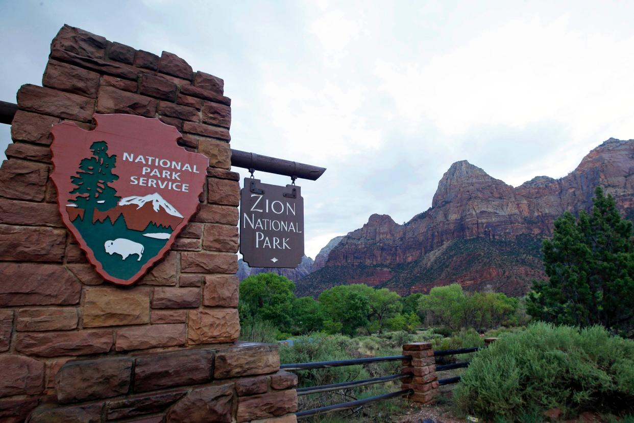 A sign welcomes visitors to Zion National Park in Utah. Park officials are urging travelers to be prepared for crowds and some delays if they visit over the busy Memorial Day weekend.