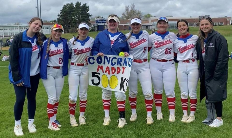 Winnacunnet senior Maddy Eaton, center, stands with teammates following Saturday's 6-1 win over Oyster River. Eaton had five strikeouts in the game, including the 500th of her career.