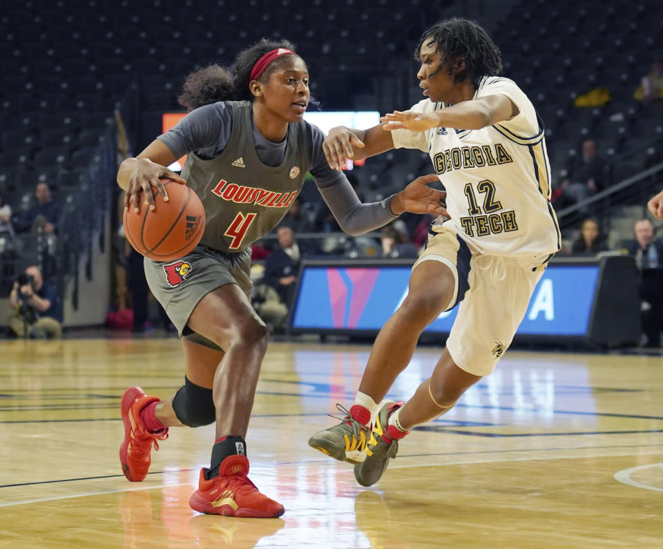 Louisville guard Elizabeth Balogun, left, drives around Georgia Tech guard Kondalia Montgomery during the second half of an NCAA college basketball game Thursday, Feb. 20, 2020, in Atlanta, Ga. (AP Photo/Tami Chappell)