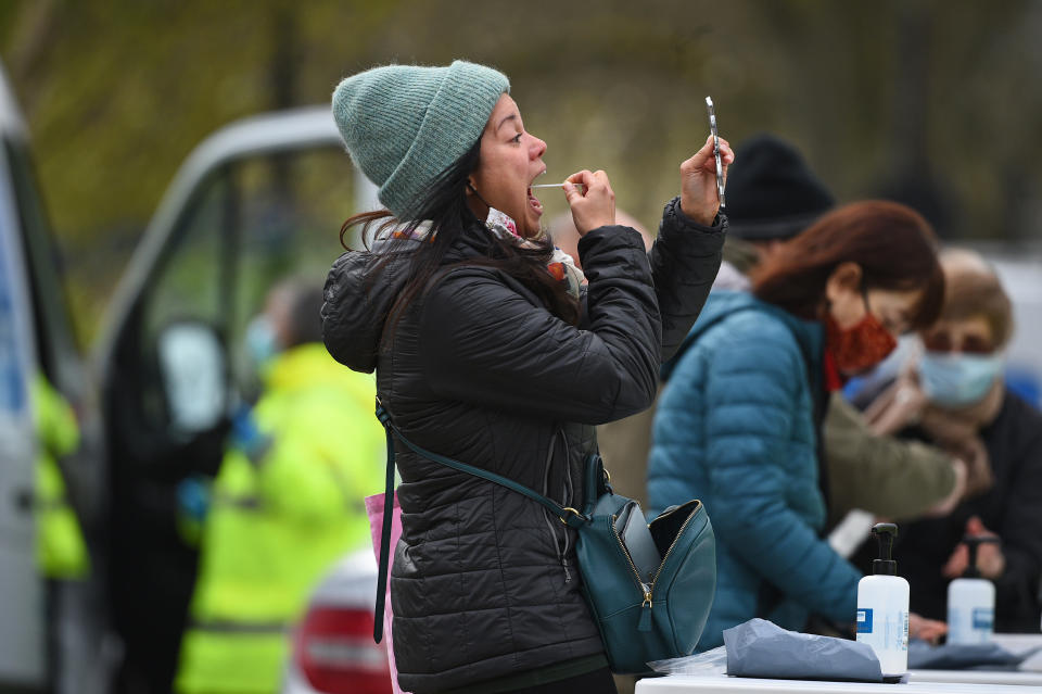 <p>People take part in coronavirus surge testing on Clapham Common, south London. Thousands of residents have queued up to take coronavirus tests at additional facilities set up after new cases of the South African variant were found in two south London boroughs. 44 confirmed cases of the variant have been found in Lambeth and Wandsworth, with a further 30 probable cases identified. Picture date: Wednesday April 14, 2021.</p>
