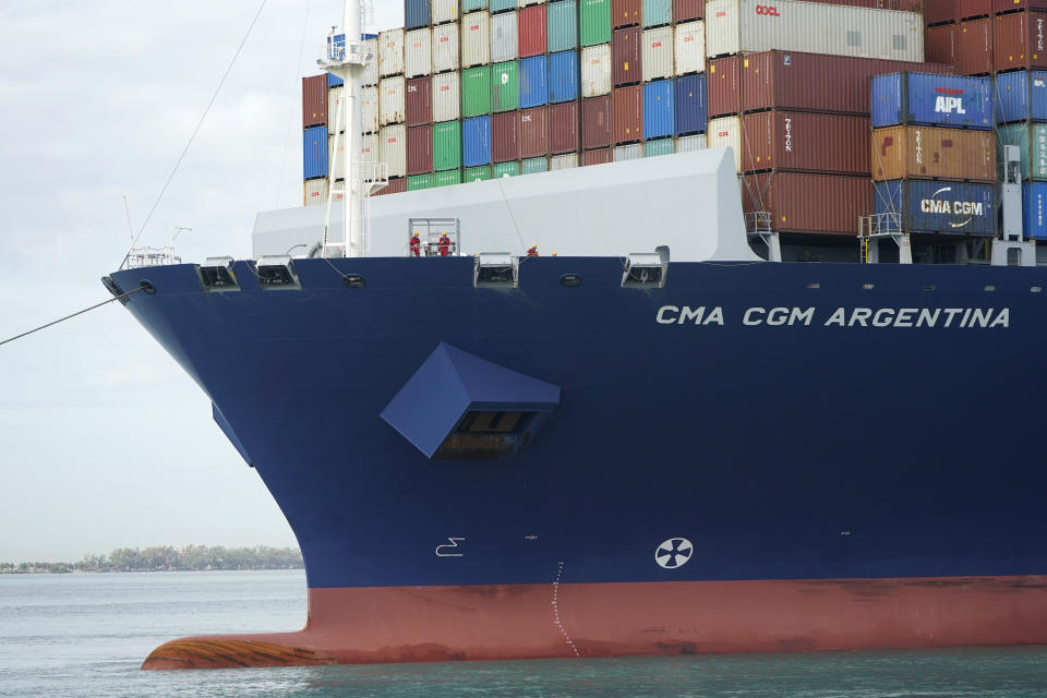 In this April 6, 2021 photo, crew members stand on the bow as the CMA CGM Argentina arrives at PortMiami, the largest container ship to call at a Florida port in Miami. Importers are contending with a perfect storm of supply trouble — rising prices, overwhelmed ports, a shortage of ships, trains, trucks — that is expected to last into 2022. (AP Photo/Lynne Sladky)