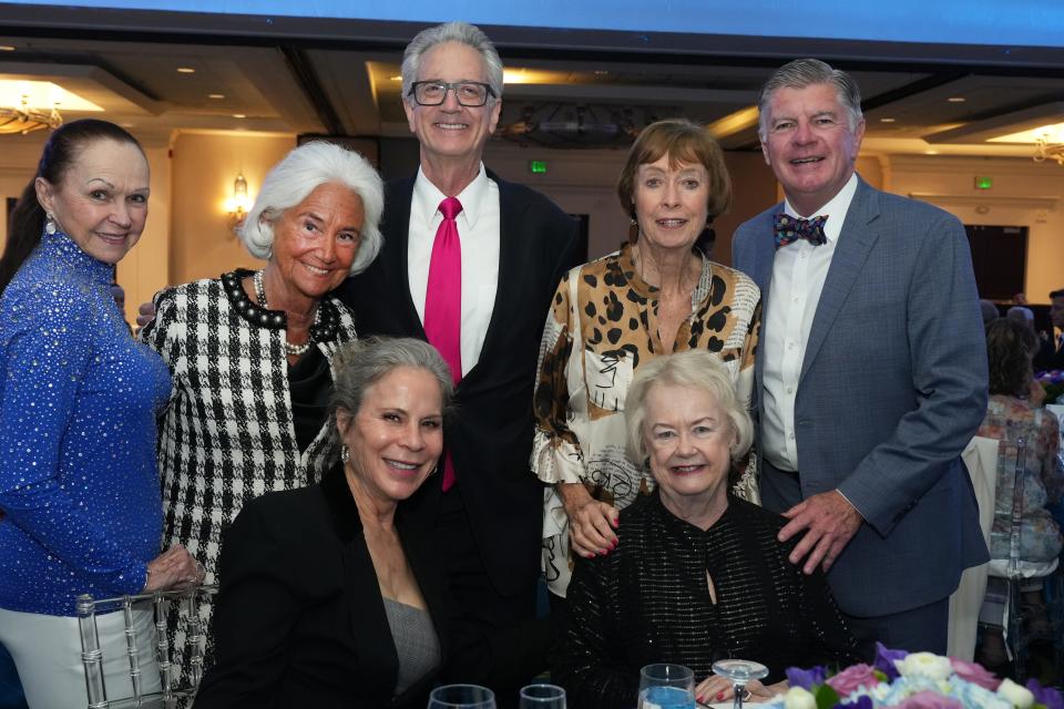 Kay Hanson, Jane Saltonstall, Brian Harnik, Diane Denkler, Peter Sturgeon, Jan Harnik (seated) and honoree Suz Hunt (seated) pose at ACT for MS' 25th anniversary gala on April 6, 2024.